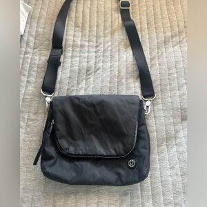 Black Lululemon crossbody bag. Lots of pockets, good condition